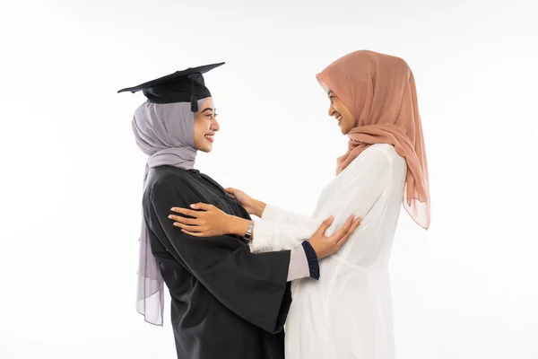 Happy Graduate Female Student Wearing Toga Hugging Her Mother Isolated — Φωτογραφία Αρχείου