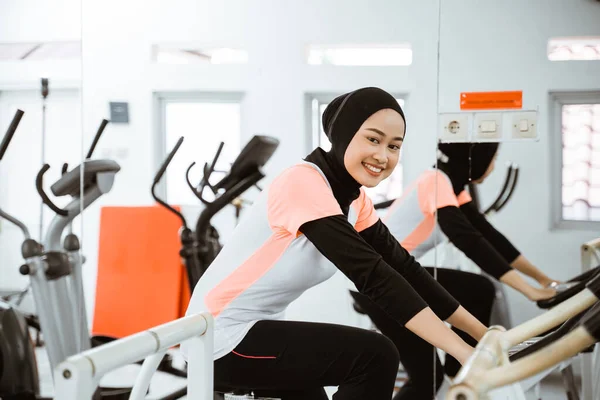 Attractive Muslim Woman Exercising Static Bike Gym — Stok fotoğraf