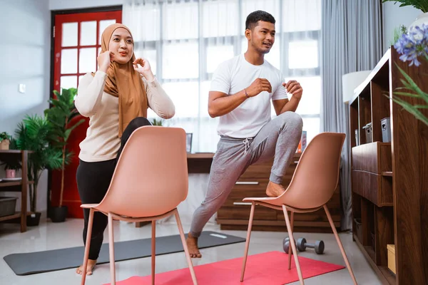 Modern Young Asian Couple Exercising Home Using Chair Help Them — Stockfoto