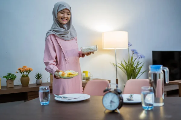 muslim woman wake up early to have a morning breakfast on fasting month. sahur concept in ramadan