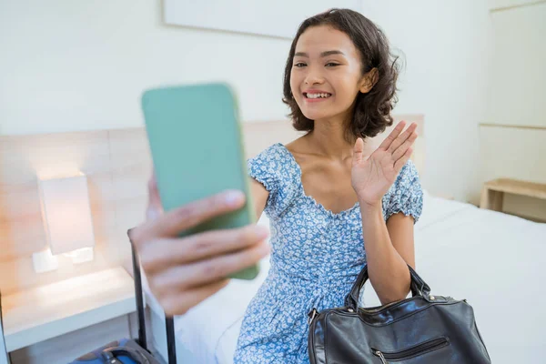 Female Guest Sitting Bed Making Video Call Using Smartphone Hotel — Foto Stock