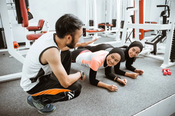 Two Muslim Woman Doing Plank Gym Trainer Teaching Them — 스톡 사진