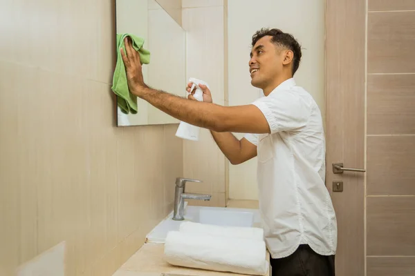Asian Male Janitor Spraying Wiping Mirror Rag Bathroom — Zdjęcie stockowe