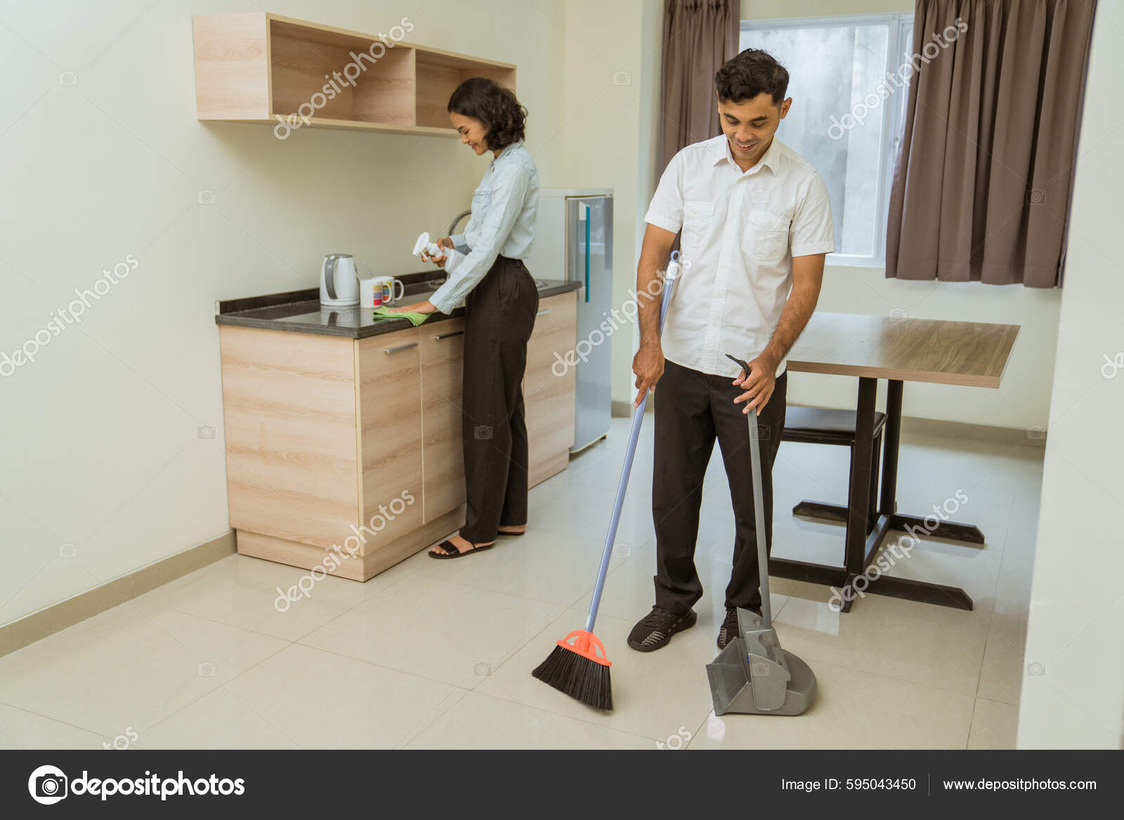 Male Janitor Sweeping Female Janitor Wiping While Cleaning Hotel Room —  Stock Photo © odua #595043450