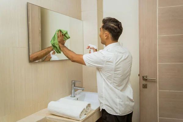 Male Janitor Spraying Wiping Mirror Rag Bathroom — Zdjęcie stockowe