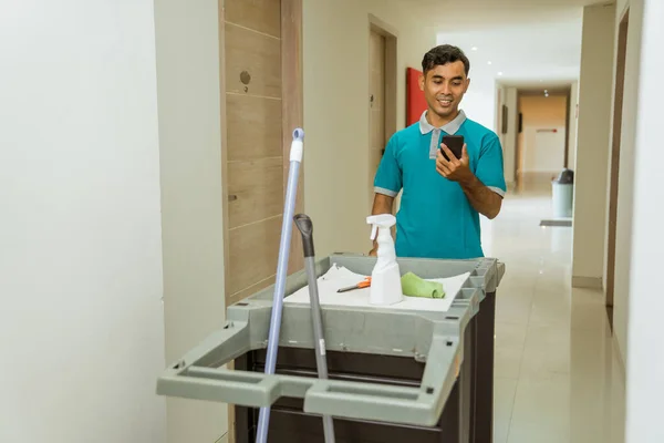 Housekeepers Using Cellphones While Pushing Carts Filled Cleaning Tools Hotel — Stockfoto