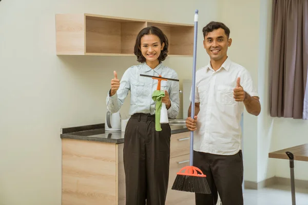 Two Cleaning Staff Holding Wipers Rags Sprays Brooms Thumbs Room — Stok fotoğraf