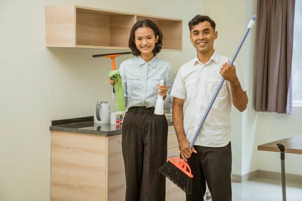 Female Male Housemaid Holding Wiper Cloth Sprayer Broom Kitchen — стоковое фото