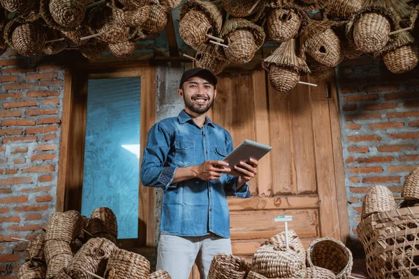 Male Entrepreneur Hat Smiling Holding Tablet Standing Close Water Hyacinth — Stockfoto