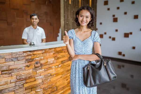 Smiling Female Guest Standing Carrying Bag Thumbs Receptionist Employee Background — Fotografia de Stock