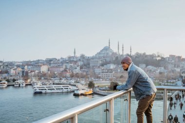 man standing on the bridge while enjoying the view of bosphorus istanbul turkey