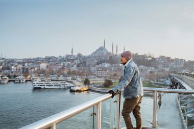 man standing on the bridge while enjoying the view of bosphorus istanbul turkey