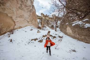 kid enjoy playing in the cave of pasabag valley cappadocia