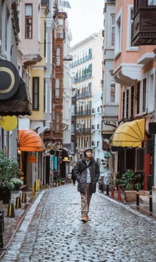 happy young asian man exploring the old city by walking