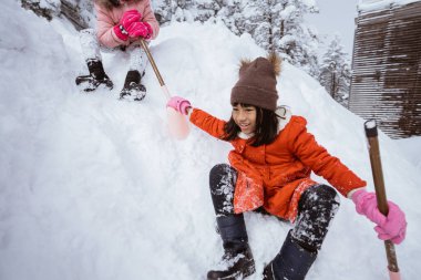 happy little girl playing outside in the snow