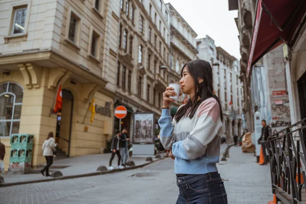 Woman Wearing Sweater Drinking Her Coffee While Standing City Centre — 스톡 사진