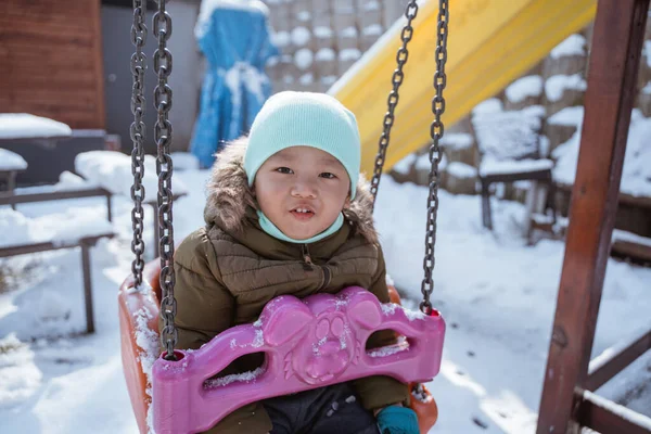 Cute Toddler Swinging Playground Cover Snow Winter — 스톡 사진