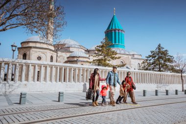asian family visiting mevlana museum in konya turkey