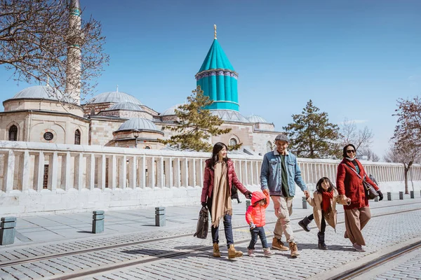 asian family visiting mevlana museum in konya turkey