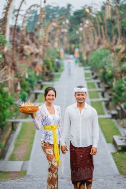 balinese people wearing traditional clothing in penglipuran village bali clipart