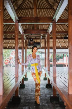 pretty balinese young woman pose to camera and smile