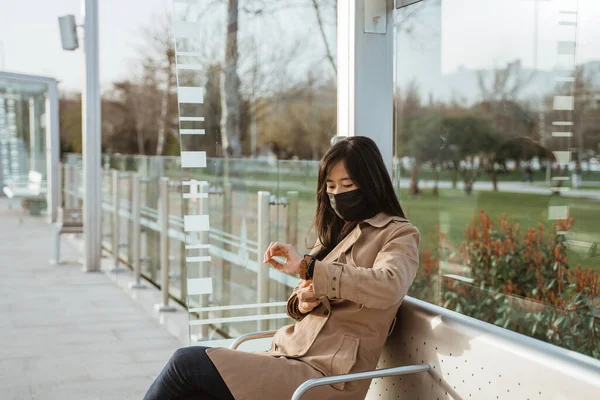 Woman Sitting Train Station Looking Her Wrist Watch Wearing Face — Foto de Stock
