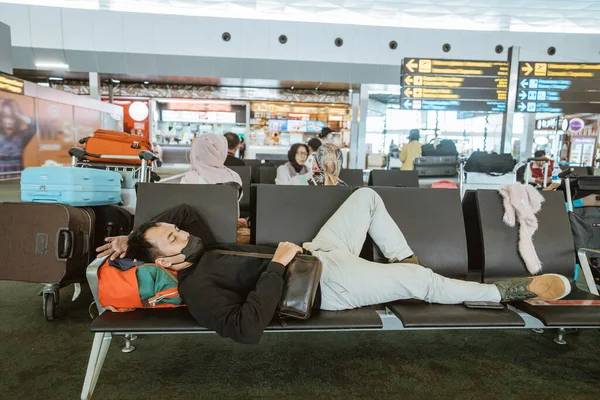 Tired Young Man Laying Bench Airport Terminal — Stockfoto