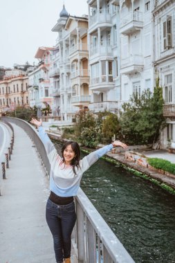 beautiful woman exploring bebek bosphorus area enjoying the beauty of historical building in arnavutkoy
