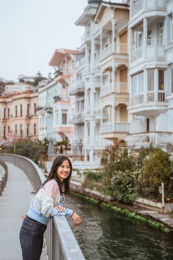 beautiful woman exploring bebek bosphorus area enjoying the beauty of historical building in arnavutkoy