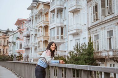 beautiful woman exploring bebek bosphorus area enjoying the beauty of historical building in arnavutkoy
