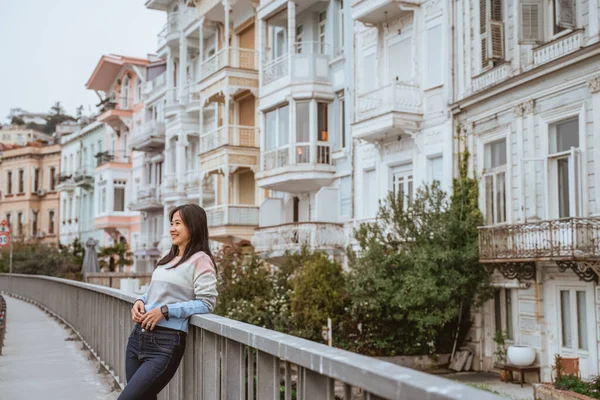 beautiful woman exploring bebek bosphorus area enjoying the beauty of historical building in arnavutkoy