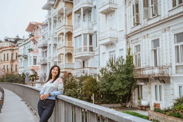 beautiful woman exploring bebek bosphorus area enjoying the beauty of historical building in arnavutkoy
