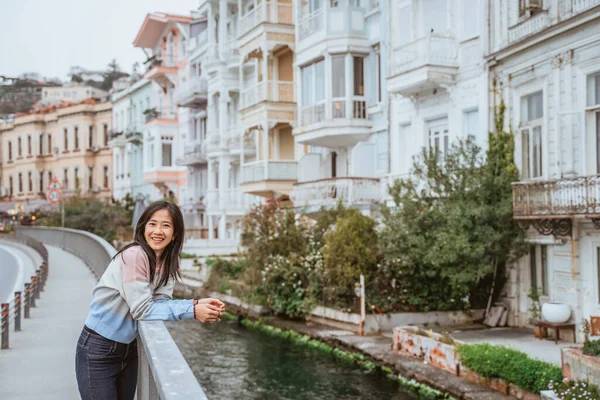 beautiful woman exploring bebek bosphorus area enjoying the beauty of historical building in arnavutkoy