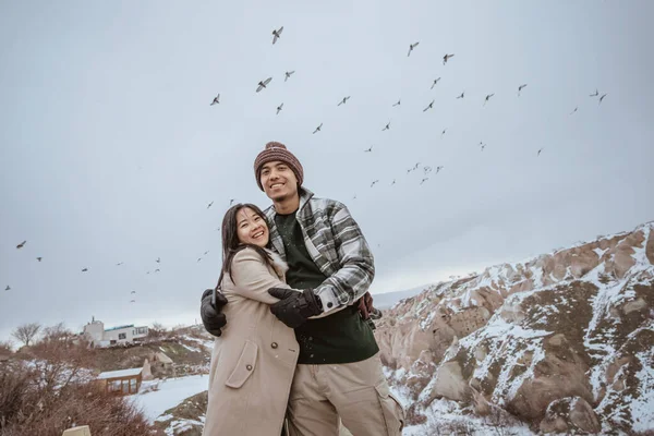 Portrait Couple Looking Camera While Pigeon Flying Circling Them — Stock fotografie