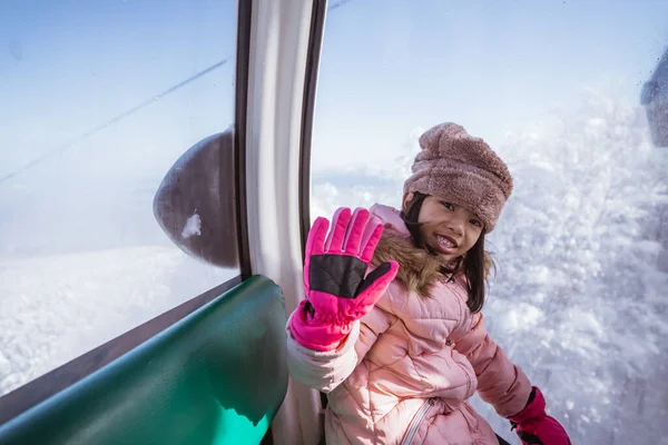 Portrait Excited Young Girl Riding Cable Car Going Top Snowy — 스톡 사진