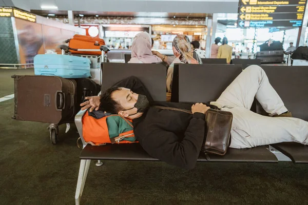Tired Young Man Laying Bench Airport Terminal — Stockfoto