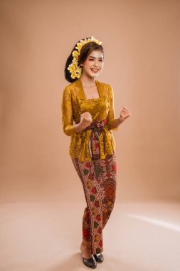 excited woman with balinese traditional kebaya costume over isolated background