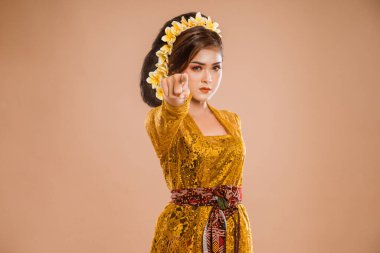 close up of balinese woman pointing to camera serious