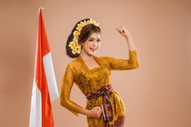 excited woman with balinese traditional kebaya costume over isolated background