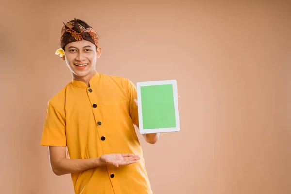 Balinese Young Man Using Tablet Showing Screen Camera Isolated Background — Fotografia de Stock