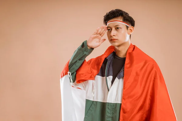 Male Athelete Indonesia Giving Salute Indonesian Flag Proudly Isolated Background — Zdjęcie stockowe