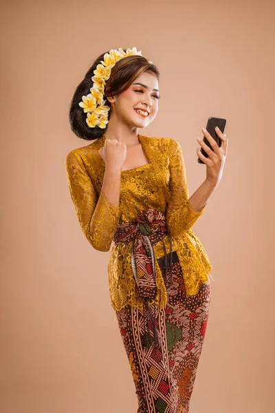 Suprised Balinese Woman Kebaya While Looking Her Mobil Phone Screen — Stok fotoğraf