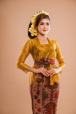 pretty asian balinese woman wearing kebaya over isolated background