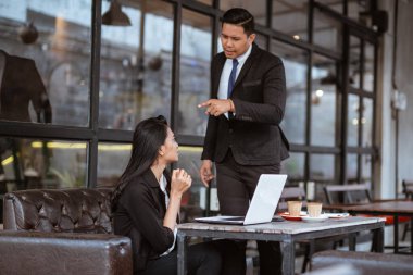 portrait of businessman blaming his partner for the company failure