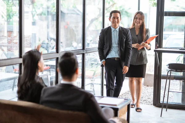 asian young worker while meeting in cafe with partner and assistant
