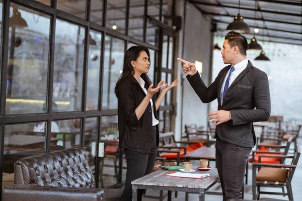 portrait of asian business people having an argument during meeting with partner