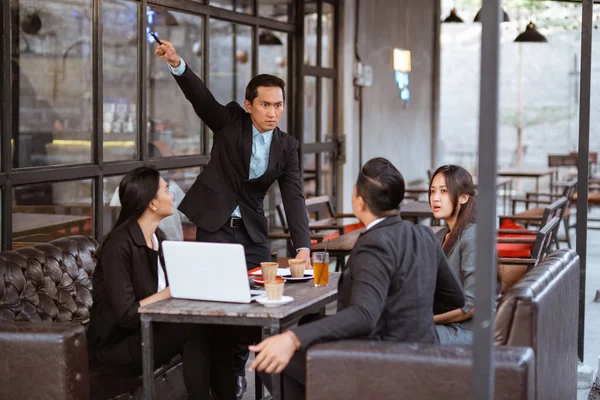 portrait of angry businessman fired his employee during meeting