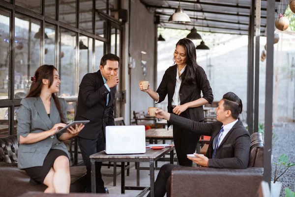 relaxed business worker enjoy drinking after finishing the meeting with partner in coffe shop