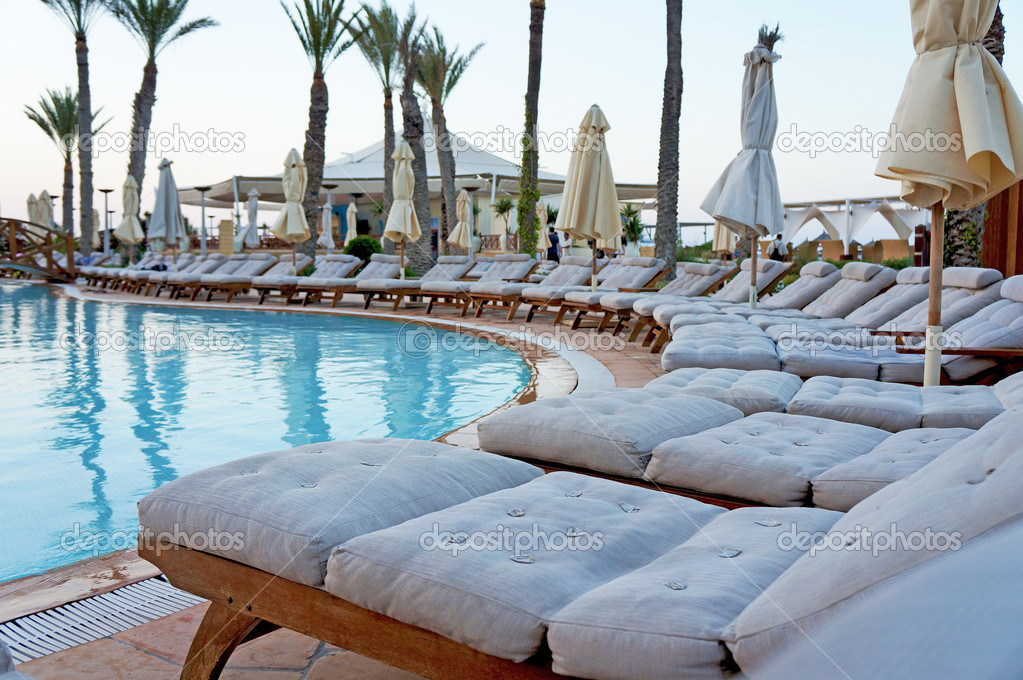 Sun loungers around a swimming pool