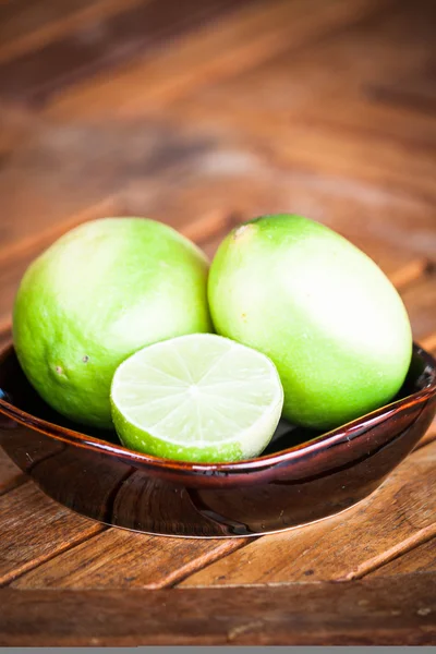 Fresh citrus lime wholes and slice on wood table — Stock Photo, Image